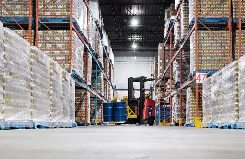 Forklift moving food product in barrels in an AIB food safety certified food grade MTE Logistix Edmonton warehouse