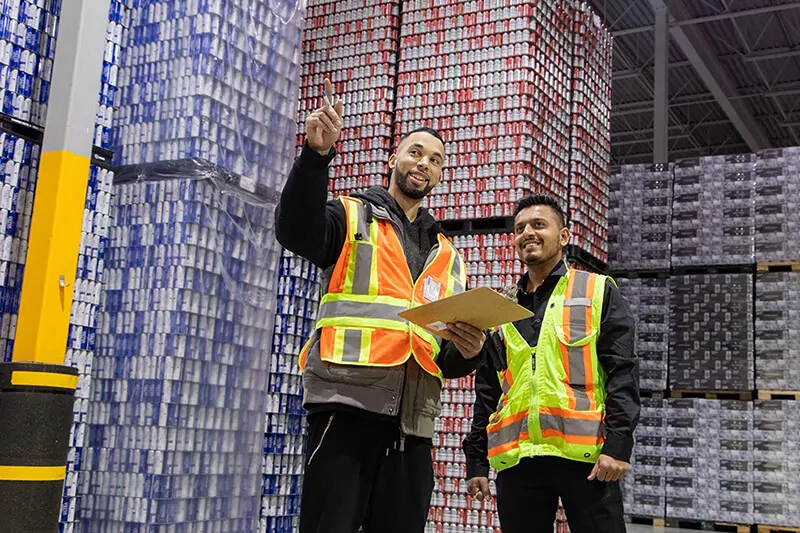 MTE Logistix employees discussing safe workplace health and safety procedures in warehouse