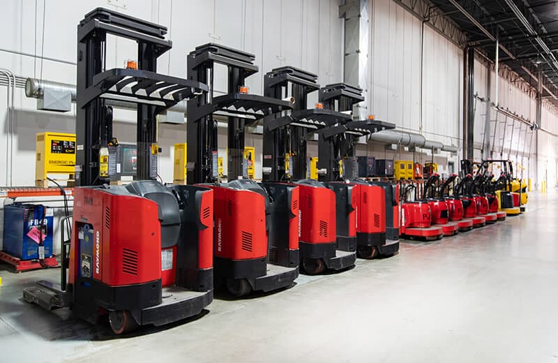 Row of powered material handling equipment in MTE Logistix Edmonton warehouse