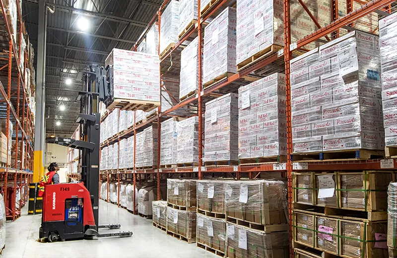 Forklift moving food product to high racking for storage in MTE warehouse