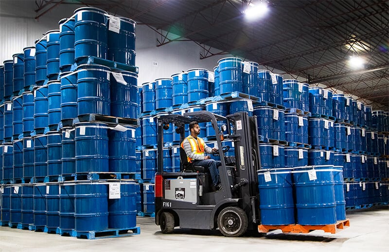Moving drums with barrel attachment at MTE Logistix Edmonton warehouse