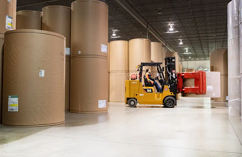 Moving paper rolls with heavy duty clamp attachment at MTE Logistix Edmonton warehouse