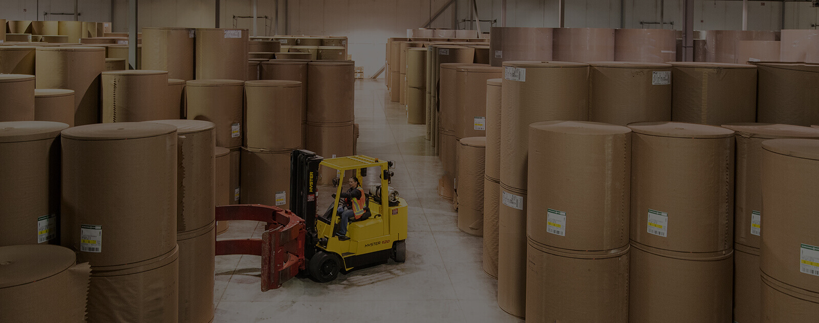 MTE warehouse_pulp & paper-forklift with clamp attachment moving paper rolls